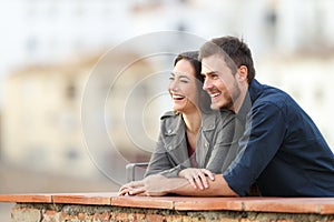 Happy couple enjoying views in a terrace on vacation