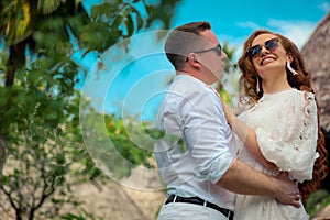 Happy couple enjoys life on a tropical island