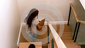 Happy couple entering in their new home with moving box