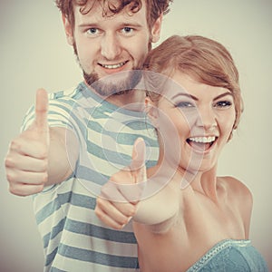 Happy couple excited smiling holding thumb up gesture,