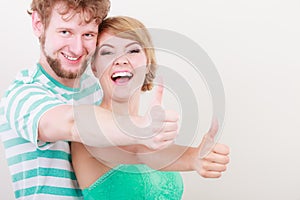 Happy couple excited smiling holding thumb up gesture,