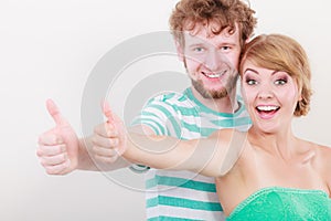 Happy couple excited smiling holding thumb up gesture,