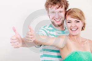 Happy couple excited smiling holding thumb up gesture,