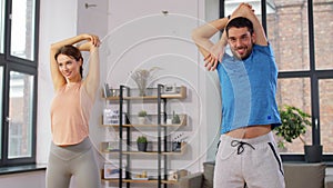 Happy couple exercising at home