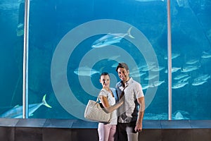Happy couple beside the fish tank