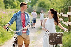 Happy couple with fixed gear bicycles in summer