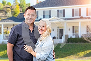 Happy Couple In Front of Beautiful House