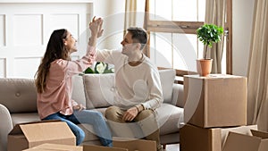 Happy couple give high five celebrate moving into new home photo