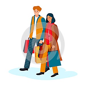 Happy couple go with paper shopping bags. Young stylish man woman go for gifts. Guy and girl in autumn winter clothes