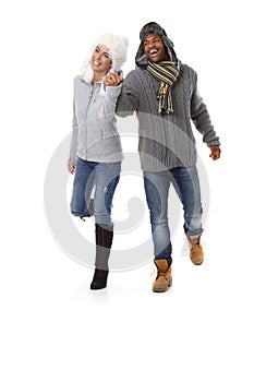 Happy couple hand in hand at wintertime smiling photo