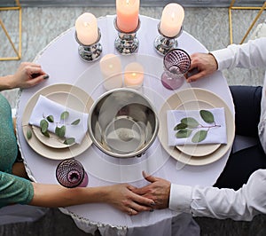 happy couple have a romantic date in a fine dining restaurant they drink wine and clinking glasses, cheers