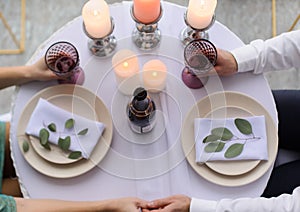 happy couple have a romantic date in a fine dining restaurant they drink wine and clinking glasses, cheers