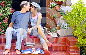 Happy couple having breakfast on the terrace