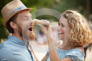 happy couple having date and eating ice cream