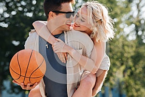 happy couple having fun on basketball playground