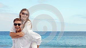 Happy couple having fun on the beach