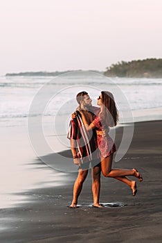 Happy couple having fun on the coast. A couple having fun on the beach in Indonesia. A man and a woman travel the world.