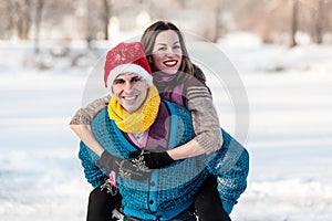 Happy couple having fun ice skating on rink outdoors.