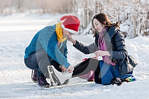 Happy couple having fun ice skating on rink outdoors.