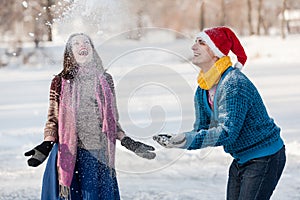 Happy couple having fun ice skating on rink outdoors.