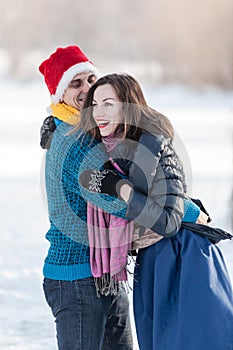 Happy couple having fun ice skating on rink outdoors.