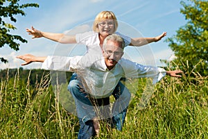 Happy couple having fun outdoors in summer