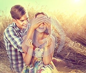 Happy couple having fun outdoors on wheat field