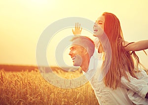 Happy couple having fun outdoors on wheat field