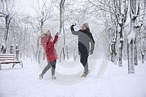 Happy couple having fun outside on winter day. Christmas vacation