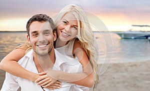 Happy couple having fun over beach background