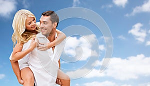 Happy couple having fun over blue sky background