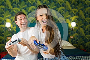Happy couple having fun playing videogames at home photo