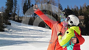 Happy Couple Having Fun On The Snow And Making Selfie. Smiling Couple. They Have Good Mood Spending Time Together.