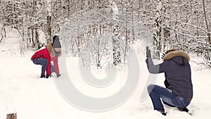 Happy couple having fun together playing snowballs