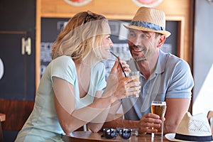 happy couple having good time drinking beer together