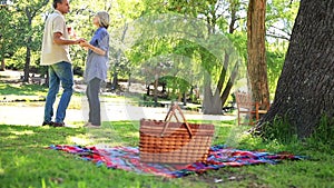 Happy couple having a picnic in the park