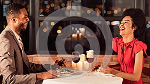 Happy Couple Having Romantic Date Talking And Laughing In Restaurant