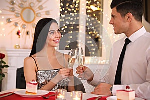 Happy couple having romantic dinner on Valentine`s day in restaurant