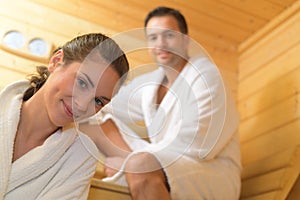 Happy couple having steam bath in sauna