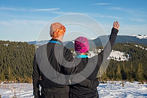 Happy couple hikers hugging during winter travel in the Carpath