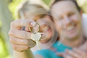 Happy Couple Holding Blank House Key Outside