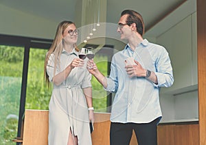 Happy couple holding glasses with red wine and celebrating
