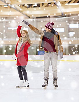 Happy couple holding hands on skating rink