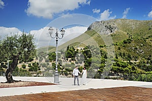 Happy couple holding hands in Sperlonga, Italy