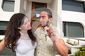 Happy couple holding key to their new house