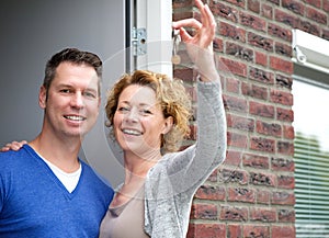 Happy couple holding keys to their new home