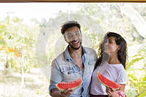 Happy Couple Holding Water Melon Slice In Hands Cheerful Man And Woman Embrace Enjoy Watermelon Outdoors