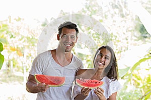 Happy Couple Holding Water Melon Slice In Hands Cheerful Smiling Man And Woman Embrace With Watermelon Outdoors