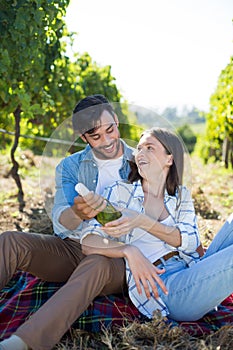 Happy couple holding winebottle