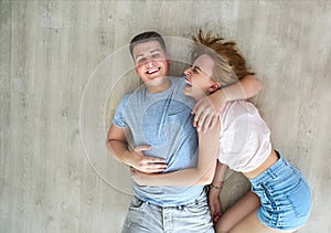 Happy couple at home relaxing on the floor